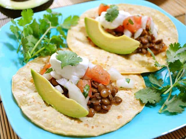 Close-up of lentil tacos with toppings.