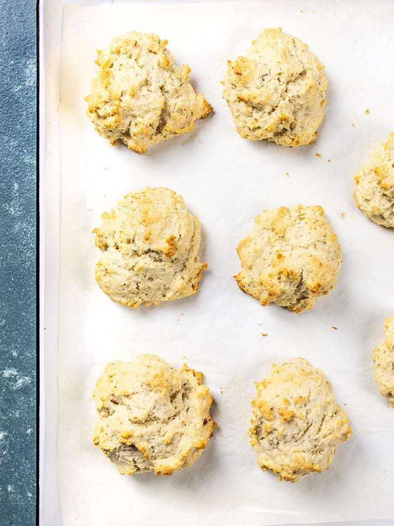 Baking sheet with baked Rosemary Pepper Drop Biscuits.