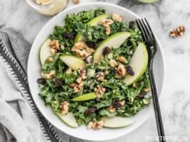 This Apple Dijon Kale Salad is tangy, sweet, and crunchy with Granny Smith apples, walnuts, raisins, and a homemade Dijon vinaigrette. BudgetBytes.com