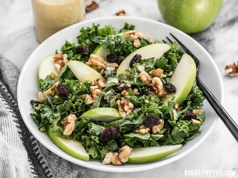 A bowl of Apple Dijon Kale Salad from the front