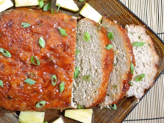 Sliced Thai turkey meatloaf on a serving plate.