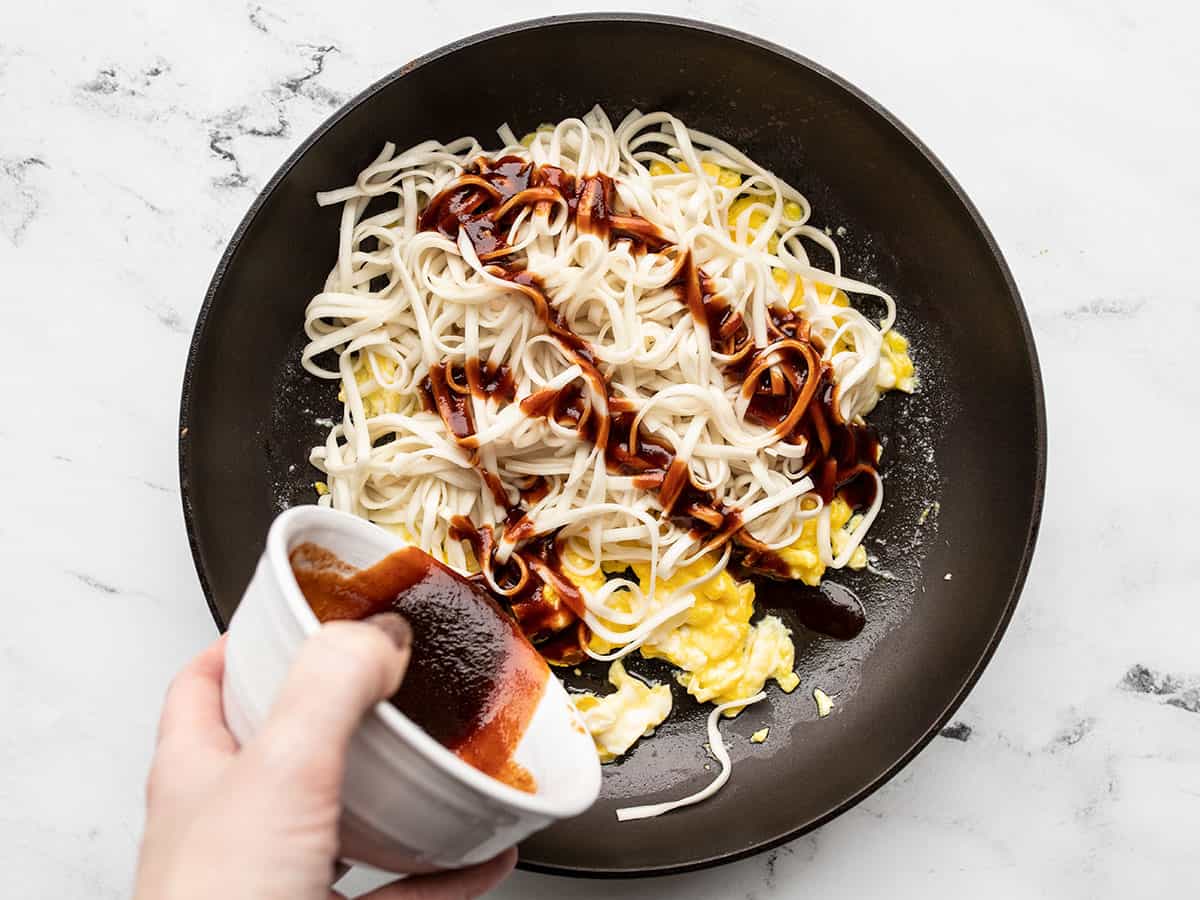 noodles and sauce added to the eggs in the skillet