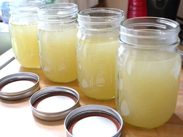 Chicken broth in a clear bowl.