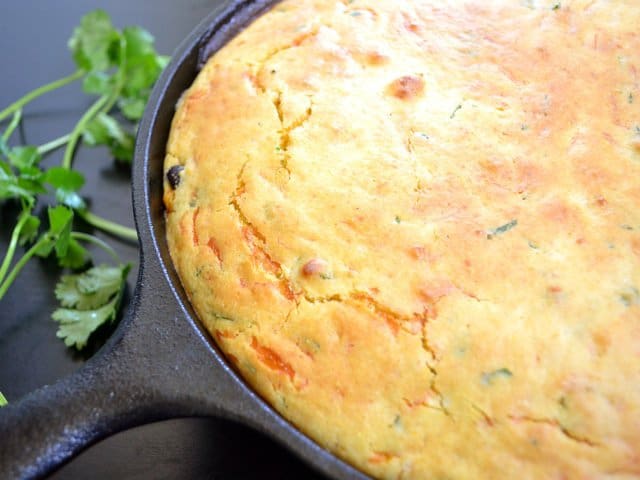 Vegetable tamale pie served on a cast iron pan.