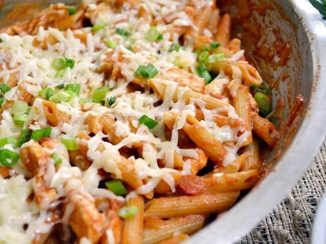 Cheesy enchilada chicken pasta served in a bowl.