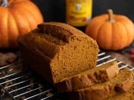 Side view of a sliced loaf of pumpkin molasses bread