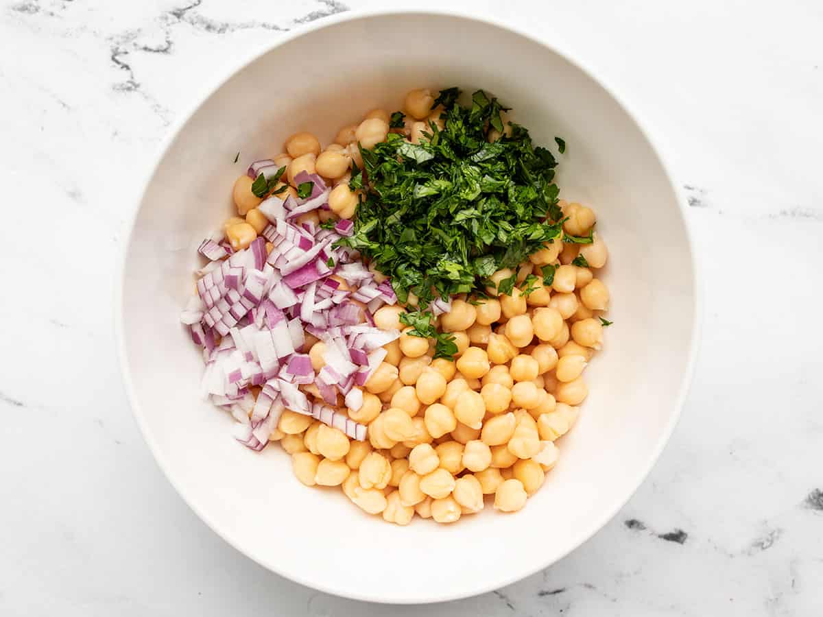 Chickpeas, parsley, and red onion in a bowl