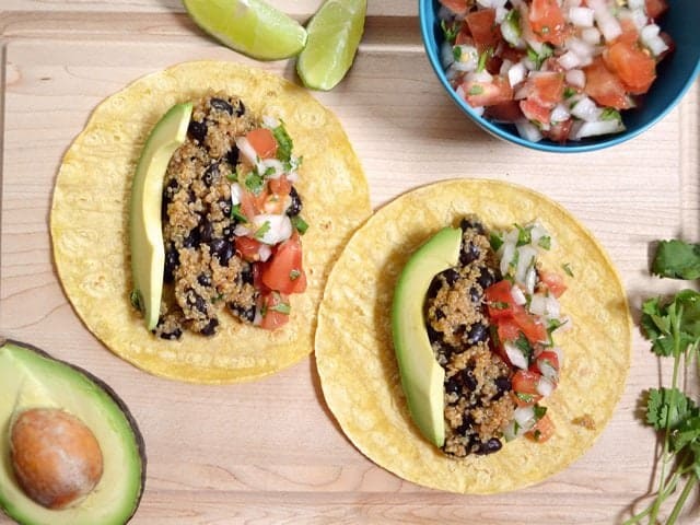 Quinoa and black bean tacos with toppings.