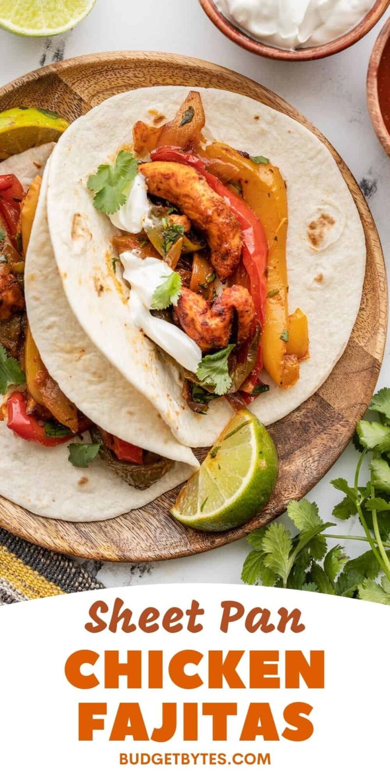 two chicken fajitas on a wooden plate