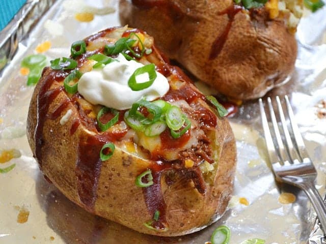 A BBQ beef stuffed potato served on a plate.