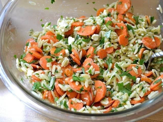 pasta and dressing added to mixing bowl 