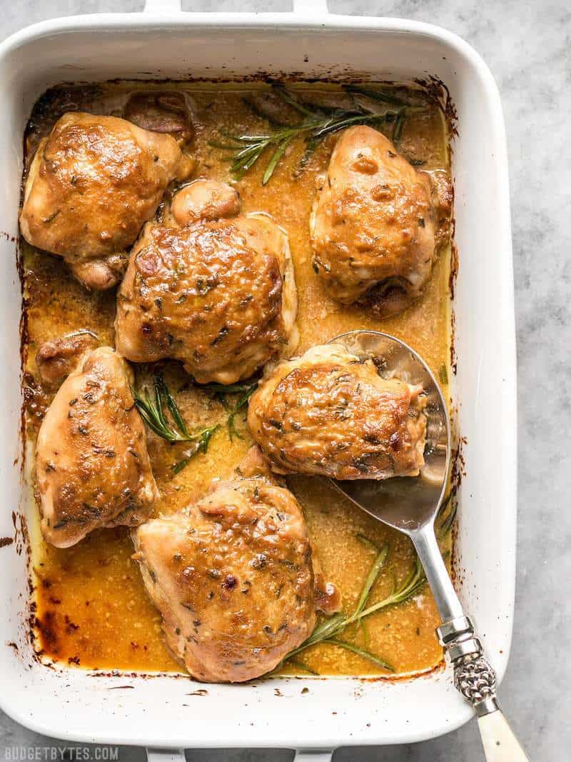 top view of a baking dish with cooked maple dijon chicken thighs 