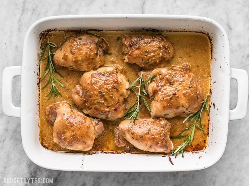 Top view of Baked maple dijon chicken thighs in baking pan 