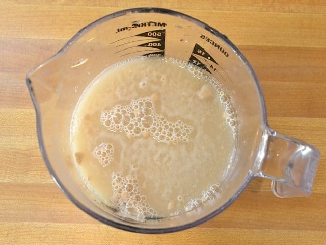 yeast, water and honey in measuring cup 