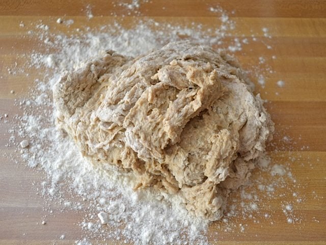 dough placed on floured countertop 