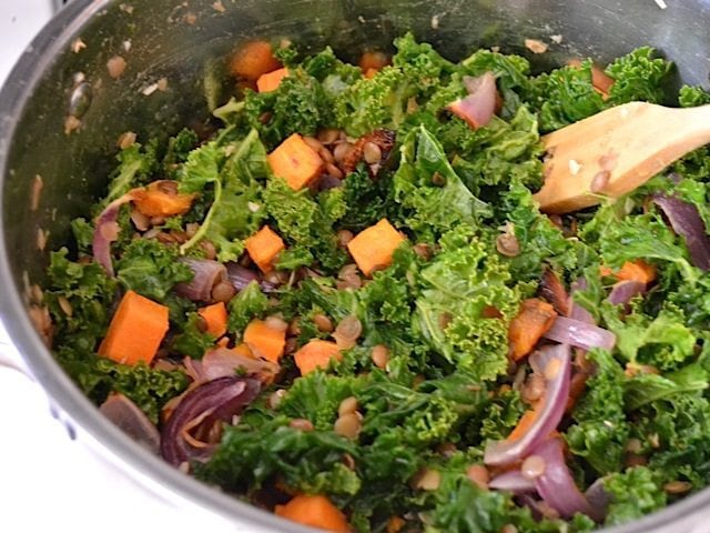 seasoning added to salad in pot 