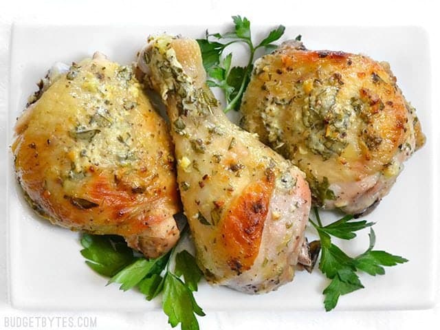 Top view of three pieces of marinated chicken on a plate 