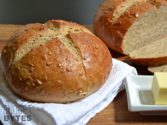 Loaf of honey sunflower bread on a cutting board.