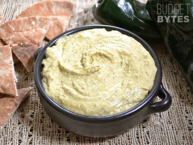 Roasted poblano hummus served with sliced bread.