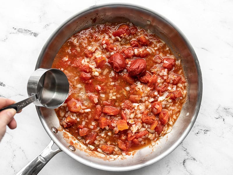 Tomato paste and water added to the skillet