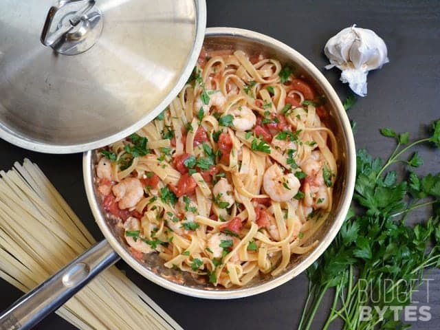 Finished spicy shrimp tomato pasta in skillet 