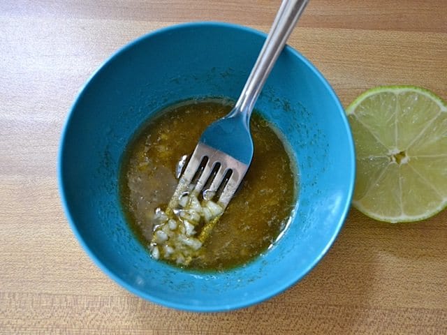 Marinade ingredients in mixing bowl with fork