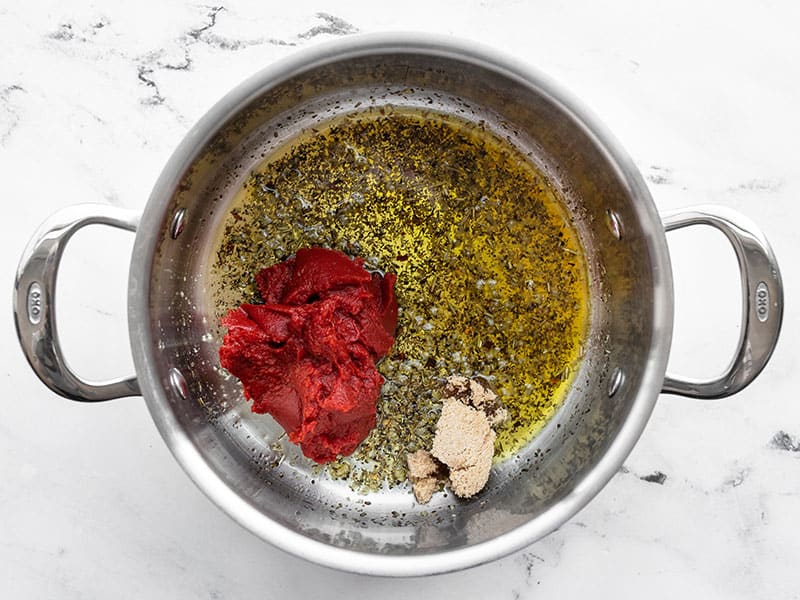 Tomato paste and brown sugar added to the pot