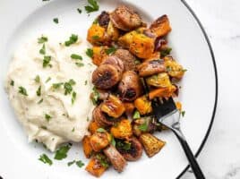 Oven roasted autumn medley on a plate with mashed potatoes and a black fork