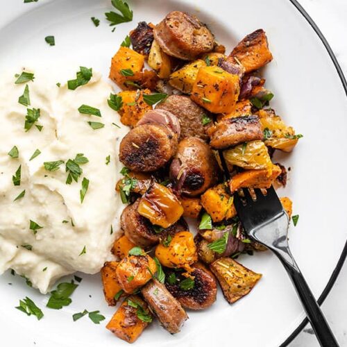 Oven roasted autumn medley on a plate with mashed potatoes and a black fork