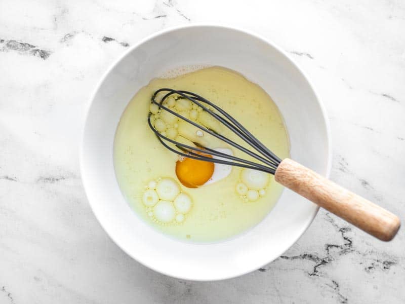 Cornbread wet ingredients in a separate white bowl