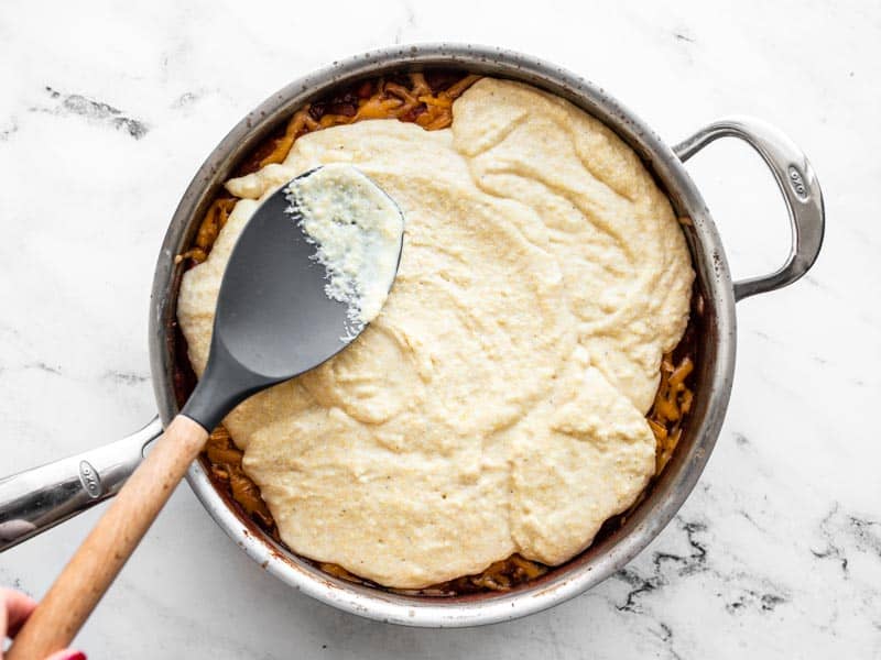 Spread cornbread batter over chili in skillet