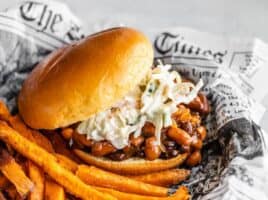 Side view of a BBQ Bean Slider on a plate with some sweet potato fries