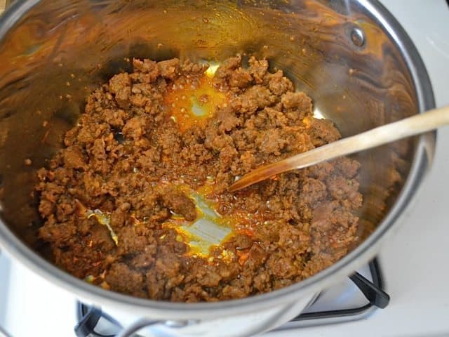 Chorizo squeezed out of casing into pot and browned 