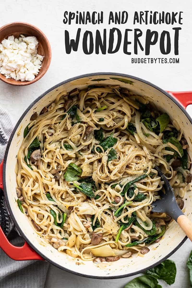 Overhead view of Spinach and Artichoke Wonderpot garnished with feta and spinach leaves on the side