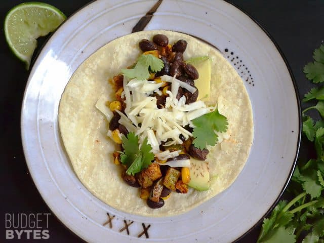 top view of one Roasted Corn & Zucchini Taco built with toppings on plate 