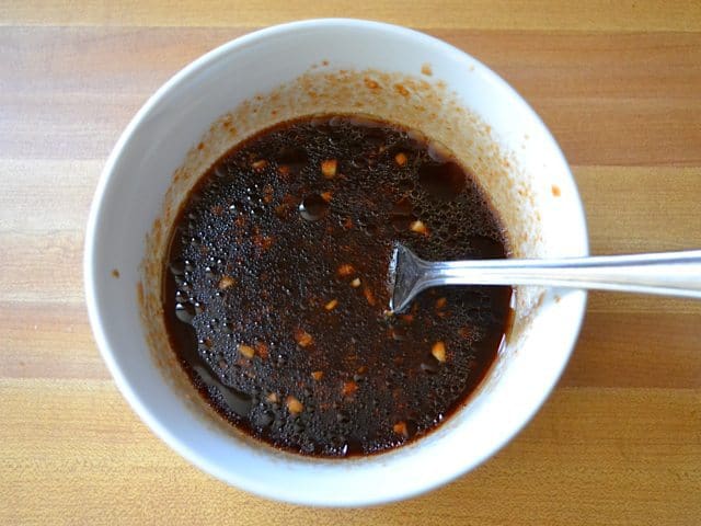 Marinade for chicken in small mixing bowl with fork 