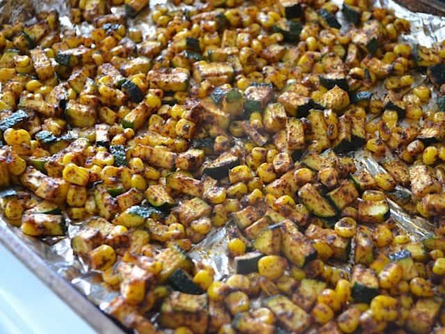 Vegetables spread out on baking sheet 