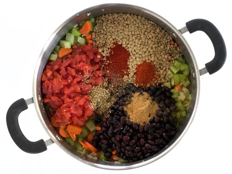 Beans, Lentils, Tomatoes and Spices added to pot with other ingredients 