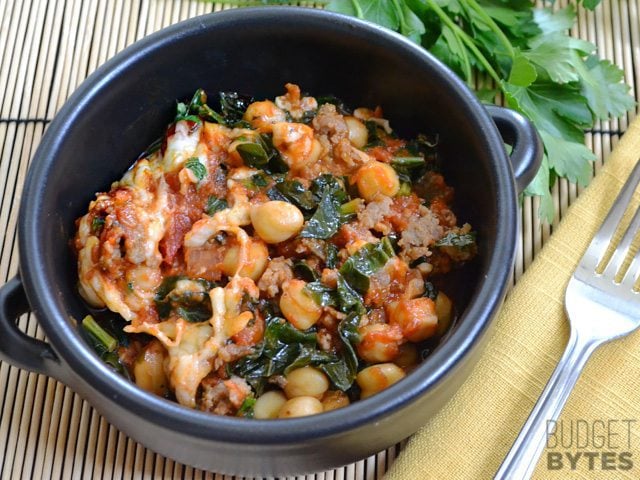 Kale & Sausage Skillet in a bowl with a fork on the side 