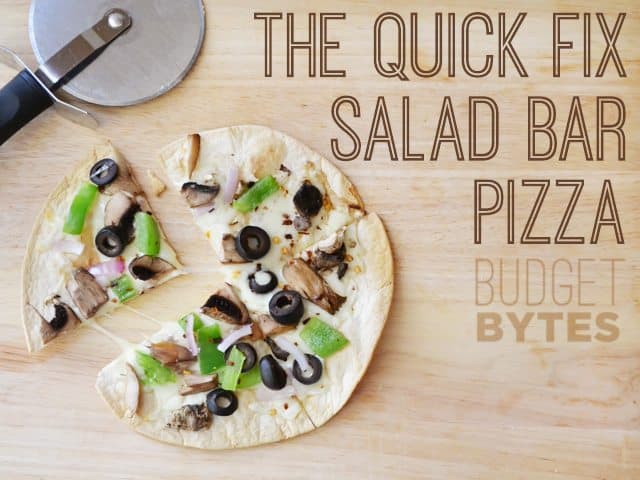 A salad bar pizza topped with fresh ingredients.