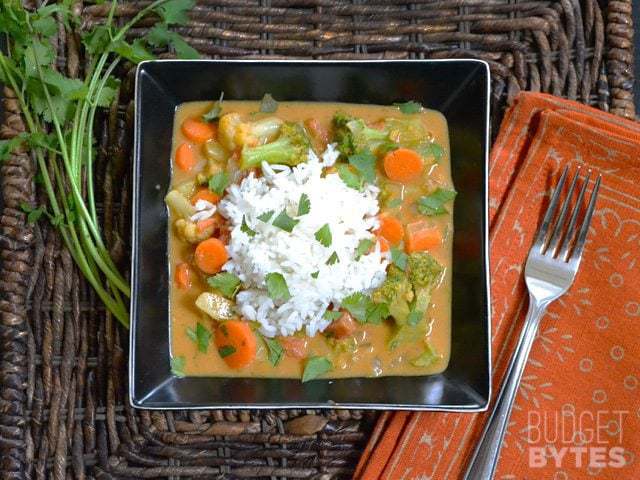 Top view of a bowl of Coconut Vegetable Curry with fork on the side 