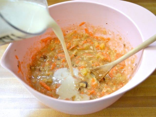 Milk being poured into mixing bowl and mixed in with other ingredients 