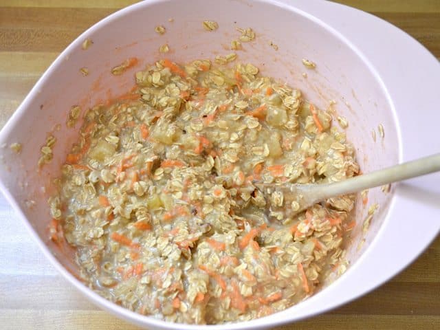 Oats stirred into mixture in mixing bowl 