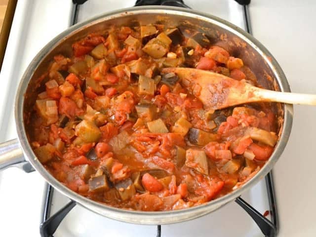 Simmered Sauce mixture in skillet with wooden spoon 