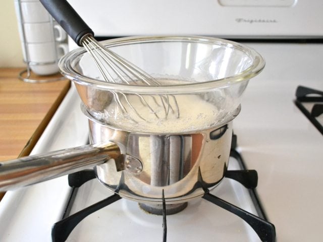 Double boiler created with mixing bowl on top of pan on stove top 