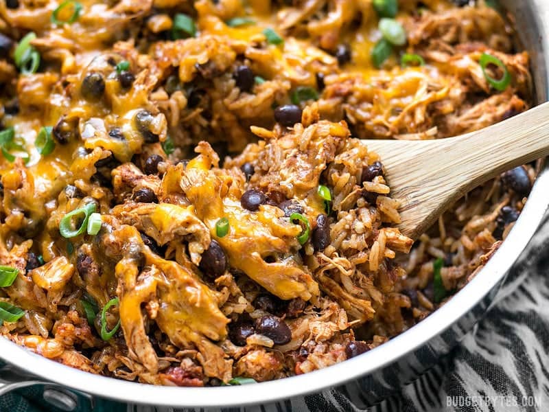 Close up of southwest chicken skillet with wooden spoon 