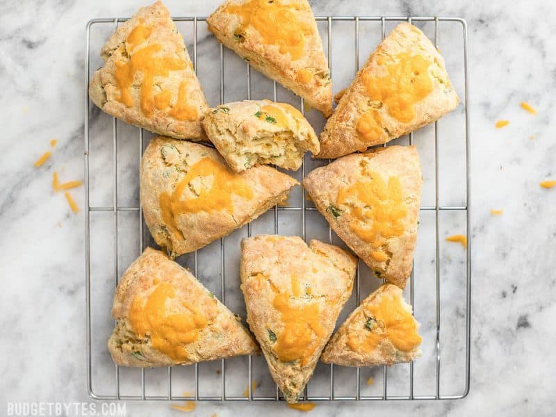 Top view of cheddar scallion scones on cooling rack 