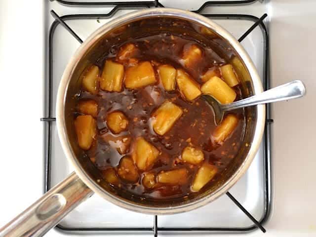 Finished Pineapple Teriyaki Sauce with pineapple chunks on stove top 