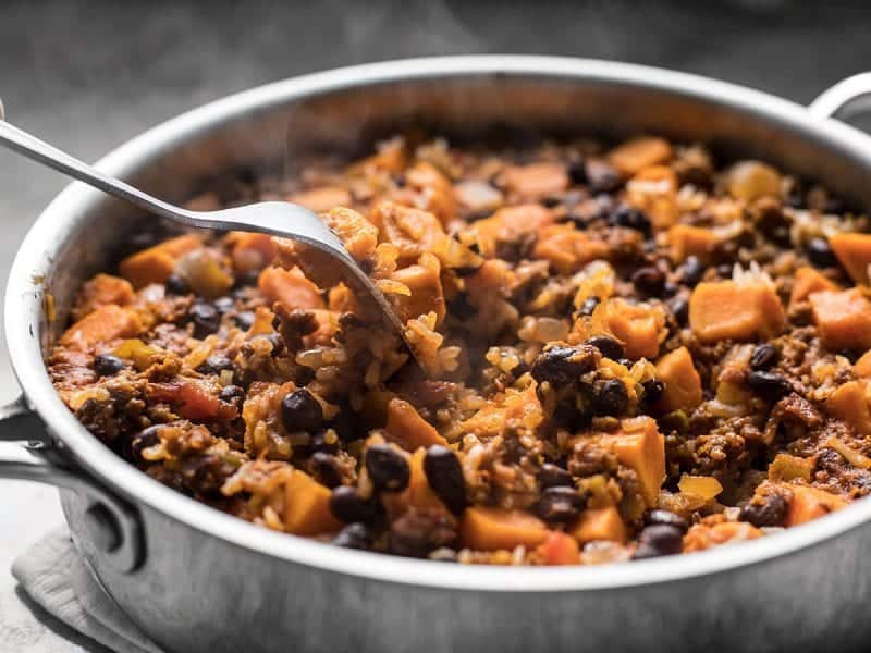 Fluffing Chorizo Sweet Potato Skillet with fork 