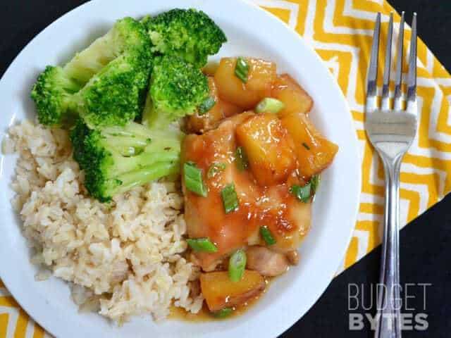 Pineapple Teriyaki Chicken Thigh plated with a side of broccoli and rice, fork on the side 